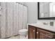 Cozy bathroom with vanity, patterned shower curtain, and neutral tones at 13247 Eastfield Village Ln, Charlotte, NC 28269
