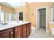 Bright bathroom features a double sink vanity and an attached, sizable closet space at 13247 Eastfield Village Ln, Charlotte, NC 28269