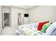 Bright bedroom features a colorful bedspread and ensuite bath access with a closet nearby at 13247 Eastfield Village Ln, Charlotte, NC 28269