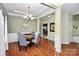 Elegant dining room with hardwood floors, chandelier, and views to the kitchen at 13247 Eastfield Village Ln, Charlotte, NC 28269