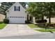 Charming home with a two-car garage, mature trees and well-maintained lawn at 13247 Eastfield Village Ln, Charlotte, NC 28269