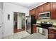 Modern kitchen with stainless steel appliances, wooden cabinets and tile backsplash at 13247 Eastfield Village Ln, Charlotte, NC 28269