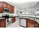 Bright kitchen with stainless steel appliances, tile floors, and breakfast nook with natural light at 13247 Eastfield Village Ln, Charlotte, NC 28269