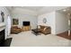 Comfortable living room with neutral tones, fireplace, and ample natural light at 13247 Eastfield Village Ln, Charlotte, NC 28269