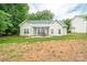 Charming home featuring a covered patio, great for outdoor dining and entertaining with lush trees in the background at 13402 Mccoy Rd, Huntersville, NC 28078