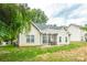 Charming home featuring a covered patio, great for outdoor dining and entertaining with lush trees in the background at 13402 Mccoy Rd, Huntersville, NC 28078