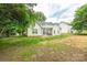 Charming home featuring a covered patio, great for outdoor dining and entertaining with lush trees in the background at 13402 Mccoy Rd, Huntersville, NC 28078