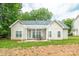 Charming home featuring a covered patio, great for outdoor dining and entertaining with lush trees in the background at 13402 Mccoy Rd, Huntersville, NC 28078