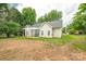 Charming home featuring a covered patio, great for outdoor dining and entertaining with lush trees in the background at 13402 Mccoy Rd, Huntersville, NC 28078