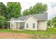 Charming home featuring a covered patio, great for outdoor dining and entertaining with lush trees in the background at 13402 Mccoy Rd, Huntersville, NC 28078
