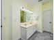 A bright bathroom featuring a double vanity, neutral wall colors and tiled floors at 13402 Mccoy Rd, Huntersville, NC 28078