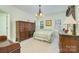 Bright bedroom with traditional furniture and decor, enhanced by natural light from the multiple windows at 13402 Mccoy Rd, Huntersville, NC 28078