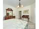 This bedroom showcases a neutral palette, complemented by elegant wooden furniture and decor at 13402 Mccoy Rd, Huntersville, NC 28078