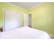 Bedroom with white carpet, green walls, white trim, and closet space at 13402 Mccoy Rd, Huntersville, NC 28078