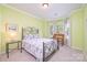 Bedroom featuring a wrought iron bed frame, neutral paint color, a window seat and a glass side table at 13402 Mccoy Rd, Huntersville, NC 28078