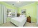 Bright bedroom with large window, side tables, and neutral color scheme at 13402 Mccoy Rd, Huntersville, NC 28078