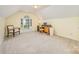 Bright bonus room with a dormer window, desk, neutral carpeting, and a comfortable chair at 13402 Mccoy Rd, Huntersville, NC 28078