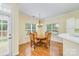 Cozy dining room with wood floors, chandelier, and natural light from the two windows with view of outside at 13402 Mccoy Rd, Huntersville, NC 28078