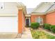 Close up of the home's brick exterior, front door and attached two-car garage at 13402 Mccoy Rd, Huntersville, NC 28078
