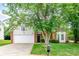 Inviting single-Gathering home with landscaped front yard, brick accents, and attached two-car garage at 13402 Mccoy Rd, Huntersville, NC 28078