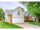 Charming home featuring a two-car garage, brick accents, and a well-manicured lawn at 13402 Mccoy Rd, Huntersville, NC 28078