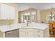 Bright kitchen with white cabinets and stainless steel appliances, seamlessly flowing into the living spaces at 13402 Mccoy Rd, Huntersville, NC 28078
