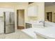 Bright kitchen with white cabinets, stainless steel appliances, and solid surface countertops at 13402 Mccoy Rd, Huntersville, NC 28078
