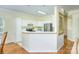 Bright kitchen featuring white cabinets, stainless steel appliances, and an island with eat-in bar at 13402 Mccoy Rd, Huntersville, NC 28078