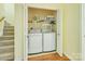 Convenient laundry area with modern washer and dryer, next to the stairs at 13402 Mccoy Rd, Huntersville, NC 28078