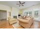 Open living space with hardwood floors, a fireplace, and large windows for natural light at 13402 Mccoy Rd, Huntersville, NC 28078