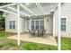 Covered patio with an outdoor dining set, providing a cozy space for entertaining or relaxing outdoors at 13402 Mccoy Rd, Huntersville, NC 28078