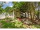 Backyard shed with small garden, rock features, and red pavers at 13622 Stringfellow Ln, Charlotte, NC 28278