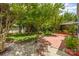 Well-manicured backyard with patio, garden, and shady trees at 13622 Stringfellow Ln, Charlotte, NC 28278