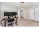 Bedroom with neutral walls, carpet floors, closet, and modern desk setup at 13622 Stringfellow Ln, Charlotte, NC 28278