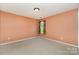 Minimalist bedroom features a small window and neutral carpet at 13622 Stringfellow Ln, Charlotte, NC 28278