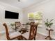Bright dining area offers a glass table and chairs beneath recessed lighting, next to a wall-mounted TV at 13622 Stringfellow Ln, Charlotte, NC 28278