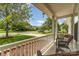 Relaxing front porch with wicker chairs, offering a tranquil view of the landscaped yard and quiet neighborhood street at 13622 Stringfellow Ln, Charlotte, NC 28278