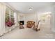 Spacious living room with fireplace and large windows providing ample natural light, creating an inviting atmosphere at 13622 Stringfellow Ln, Charlotte, NC 28278