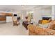 Cozy living room boasts a fireplace, neutral carpet, and seamlessly connects to the kitchen and dining areas at 13622 Stringfellow Ln, Charlotte, NC 28278