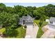 A charming home with well-maintained landscaping, a long driveway, and surrounded by lush greenery at 13832 Queenswater Ln, Charlotte, NC 28273