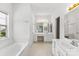 A spacious bathroom with double vanity, tub, and white cabinetry at 13832 Queenswater Ln, Charlotte, NC 28273