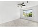 Bedroom features a ceiling fan and a large window with natural lighting at 13832 Queenswater Ln, Charlotte, NC 28273