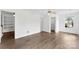 Bedroom featuring wood floors and bright, neutral paint; views of the backyard trees at 13832 Queenswater Ln, Charlotte, NC 28273