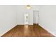 Bright bedroom with wood floors, a ceiling fan, and a connecting bathroom at 13832 Queenswater Ln, Charlotte, NC 28273