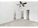 Bright bedroom features neutral carpet with views of the bathroom and hallway at 13832 Queenswater Ln, Charlotte, NC 28273