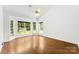 A bright bedroom featuring hardwood floors, large windows, and a vaulted ceiling at 13832 Queenswater Ln, Charlotte, NC 28273