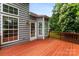 Spacious wooden deck perfect for outdoor entertaining, with lovely views of the lush backyard at 13832 Queenswater Ln, Charlotte, NC 28273