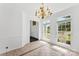 Elegant dining room with tile floors, chandelier, and lots of natural light from large windows at 13832 Queenswater Ln, Charlotte, NC 28273
