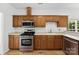 Bright kitchen featuring stainless steel appliances, wooden cabinets and white countertops at 13832 Queenswater Ln, Charlotte, NC 28273