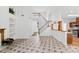 Spacious living room with white walls, tiled floors and a staircase leading to the second floor at 13832 Queenswater Ln, Charlotte, NC 28273